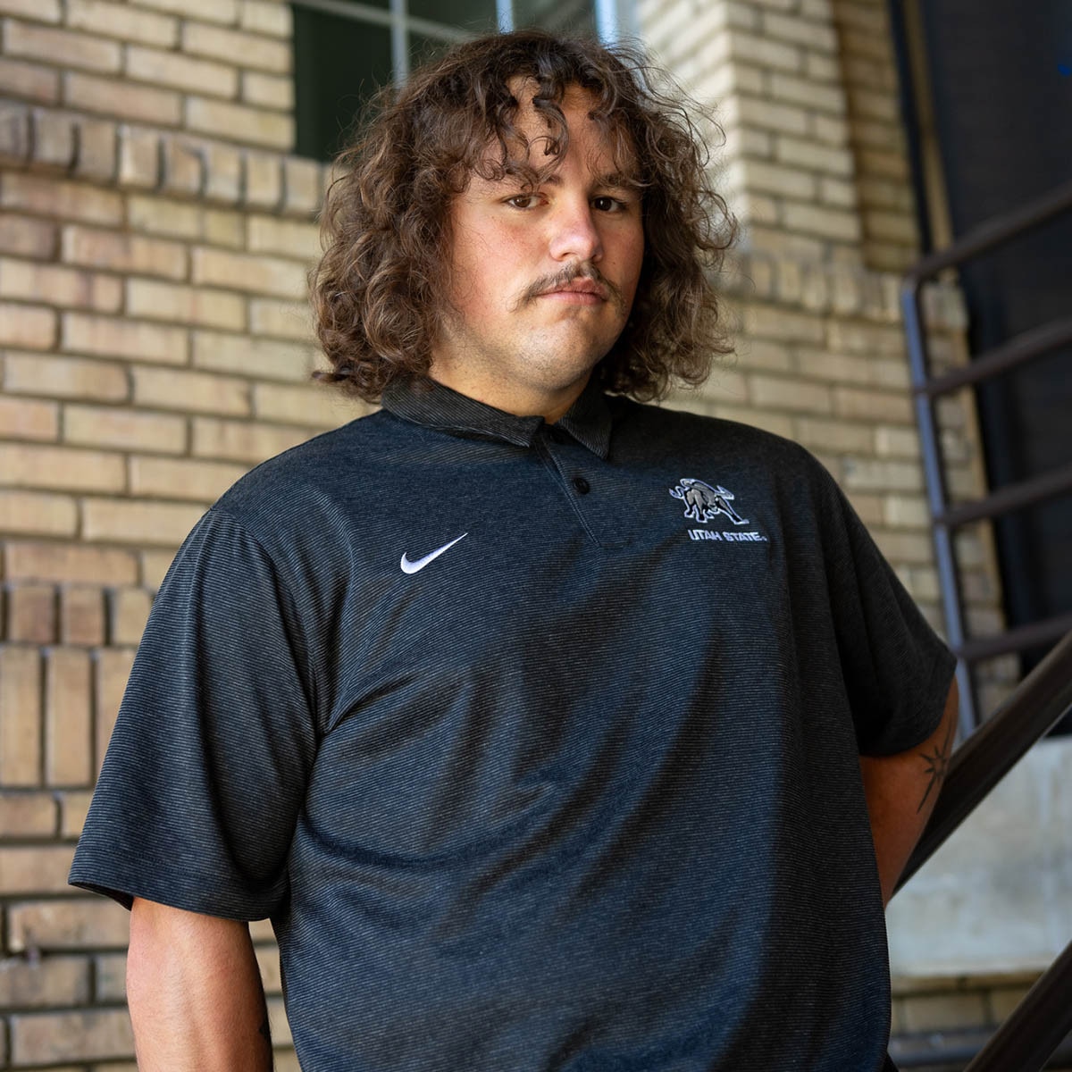 Utah State Aggie Bull embroidered Nike polo dark heather black stripe